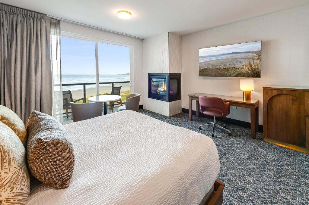 a hotel room with a bed and a desk and a window at Allred Hotel in Newport
