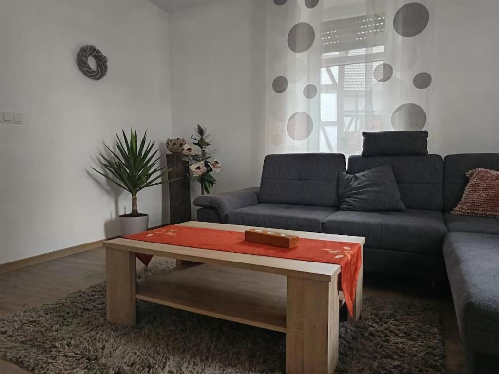 a living room with a couch and a coffee table at Im Hochparterre relaxen in Breitenbach am Herzberg