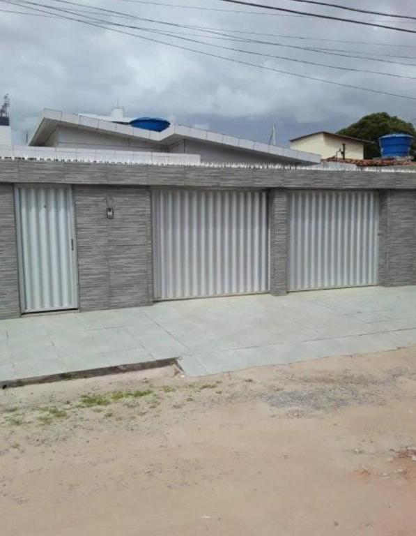 a building with two garage doors on the side of it at Casa ampla Olinda in Olinda