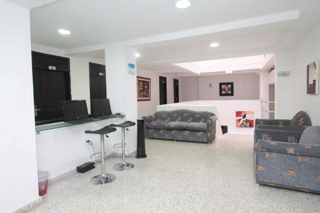 a living room with two couches and a couch at Hotel Arawak Upar in Valledupar