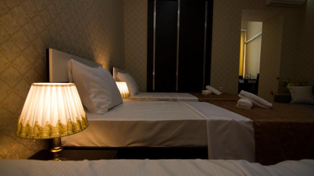 Postel nebo postele na pokoji v ubytování Hotel Care Inn