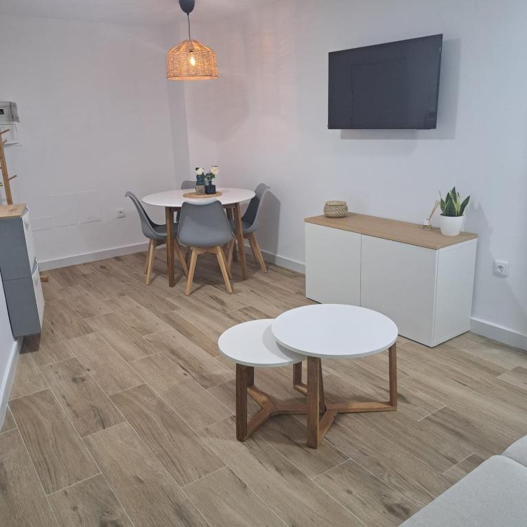 a living room with two tables and a tv at Apartamento Neron in Ronda