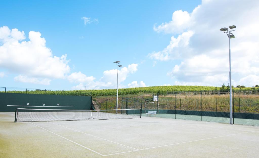 a tennis court with two tennis at Quinta do Rol in Miragaia
