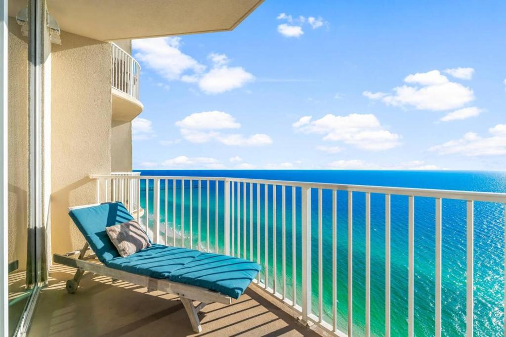 a balcony with a blue chair and the ocean at Family-Friendly Gulf-Front Condo w/Beach Access in Panama City Beach