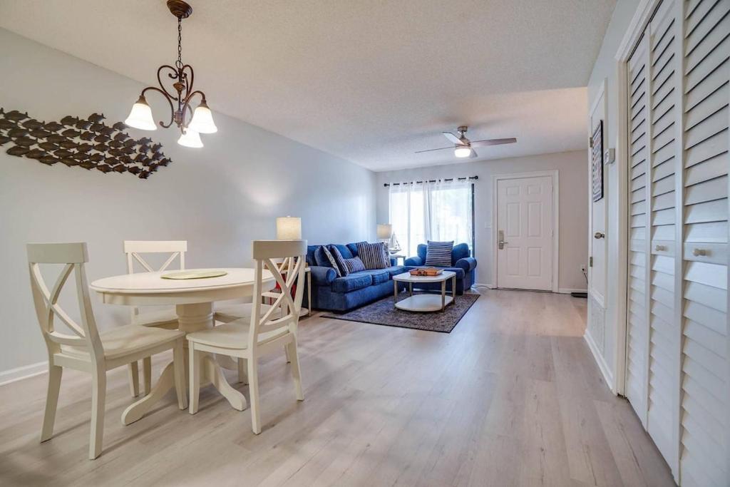 a living room with a table and a blue couch at Softsands Hideaway - Portside Resort - Sleeps 6 in Panama City Beach