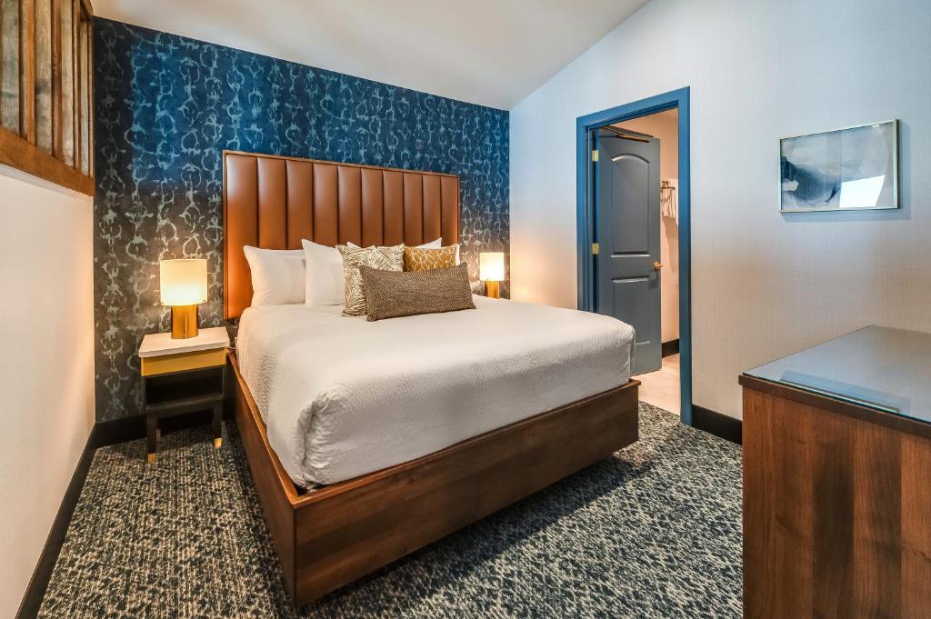 a bedroom with a bed and a blue wall at Allred Hotel in Newport