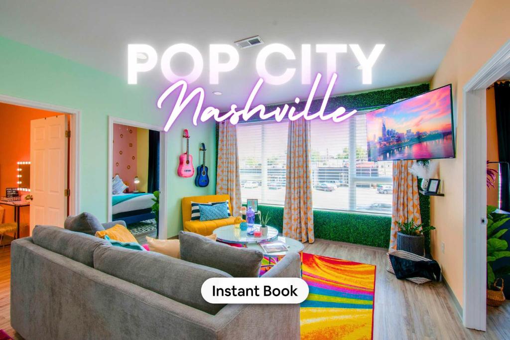 a living room with a couch and a tv at New 4 Bedroom Apt near DT Walk to restaurants in Nashville