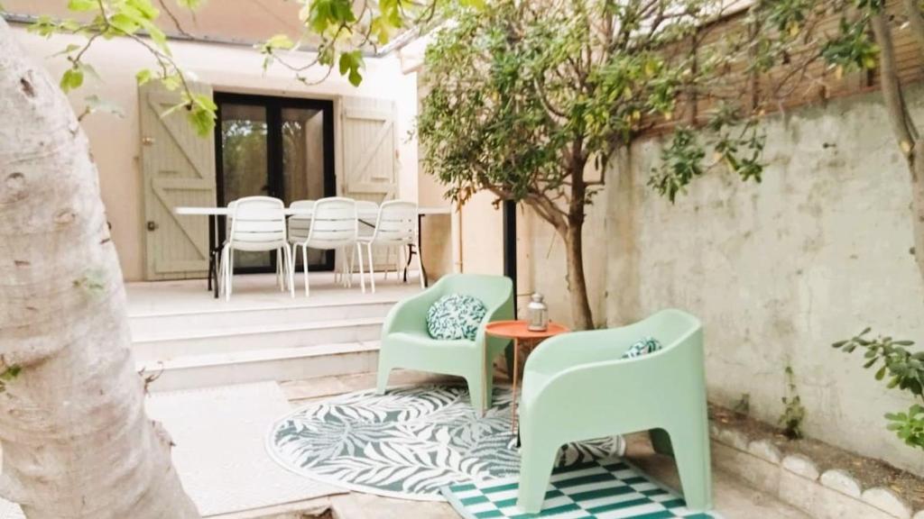 un patio avec des chaises, une table et un arbre dans l'établissement Lo' Ruino - Clim - 4 Pers - Plage - Prest 'immo, à Leucate-Plage