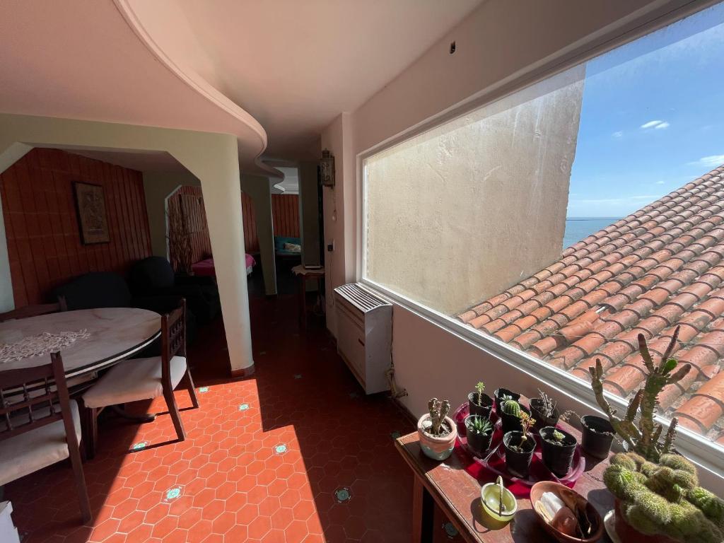 a room with a large window with a view of the ocean at Punta Iglesia in Mar del Plata