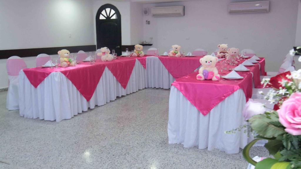 a row of tables with teddy bears on them at Hotel Arawak Upar in Valledupar
