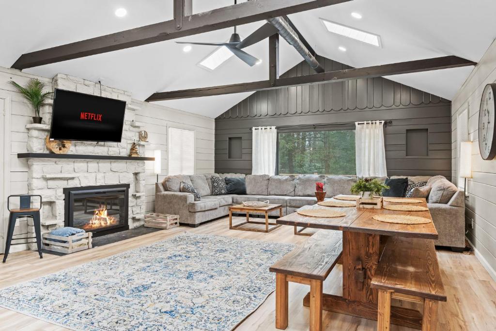 a living room with a table and a fireplace at NewReno 8BR 6BTH DECK GAMES PETS in Lake Harmony
