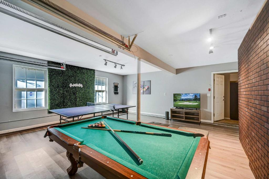 a pool table in a room with two tables at Spacious Retreat - Outdoor Oasis Games and more in Blakeslee