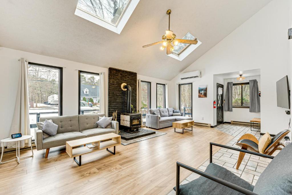 a living room with couches and a fireplace at Hot Tub and Game Room Long Pond Getaway! in Long Pond