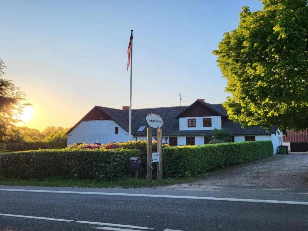 a house with a flag in front of it at Lysbjerggård in Faaborg