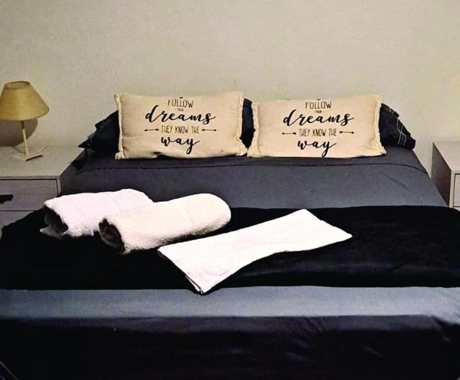 a bed with towels and pillows on top of it at Loft García in Mendoza