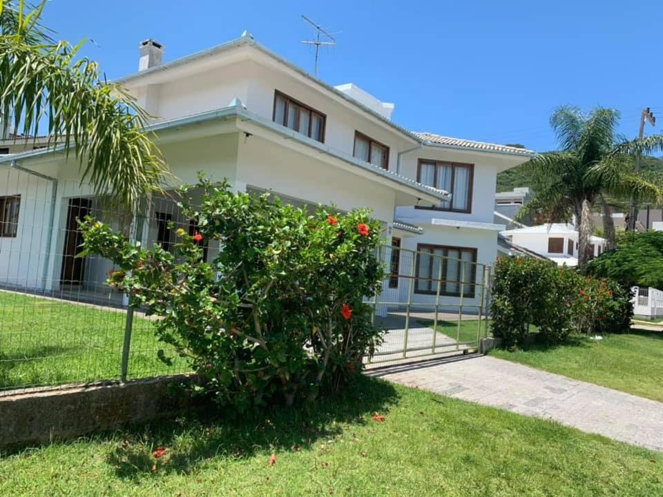 a house with a bush in front of it at Casa em praia de Garopaba 48- in Garopaba