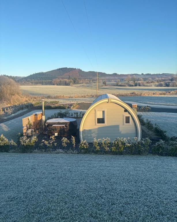 a large dome tent sitting on the side of a river at Knockmany View Glamping in Augher