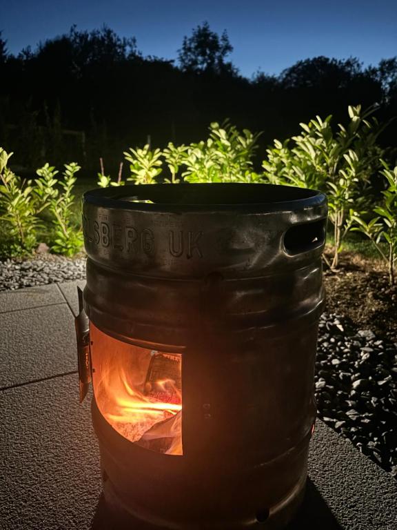 a fire in a pot with the words pipe us at Knockmany View Glamping in Augher