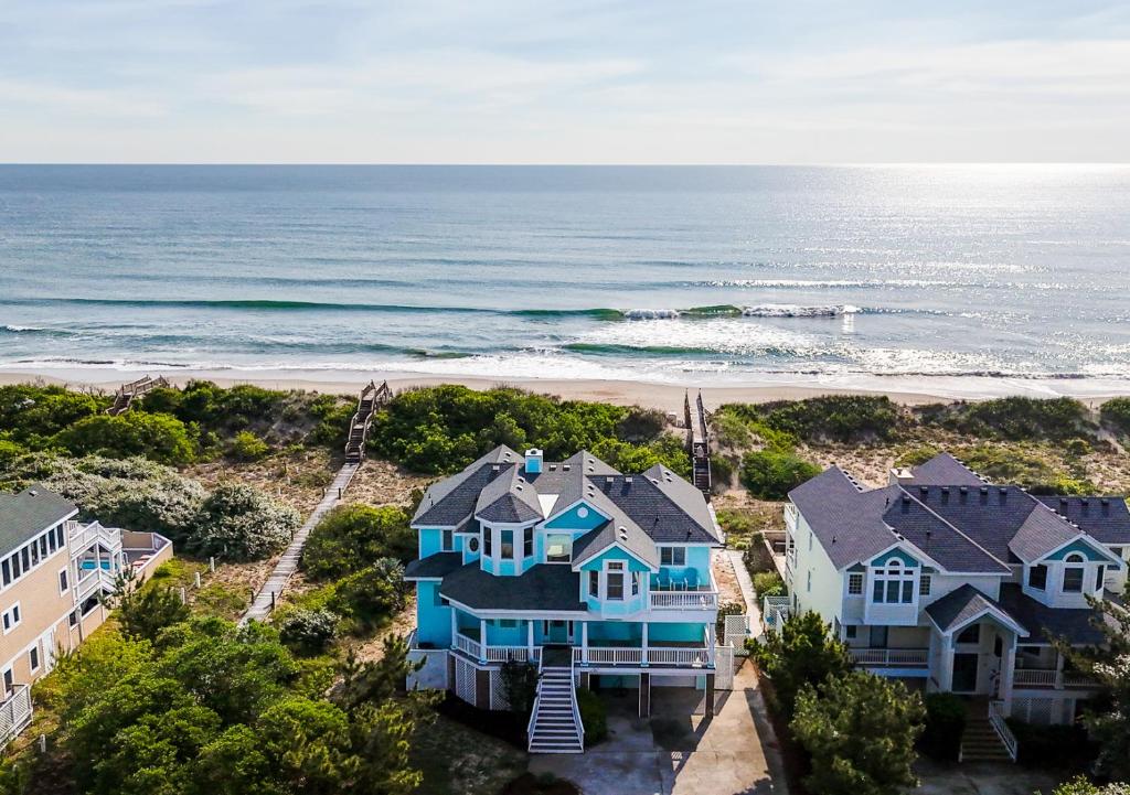 an aerial view of a house and the beach at 1398 - Alotta Coladas in Corolla