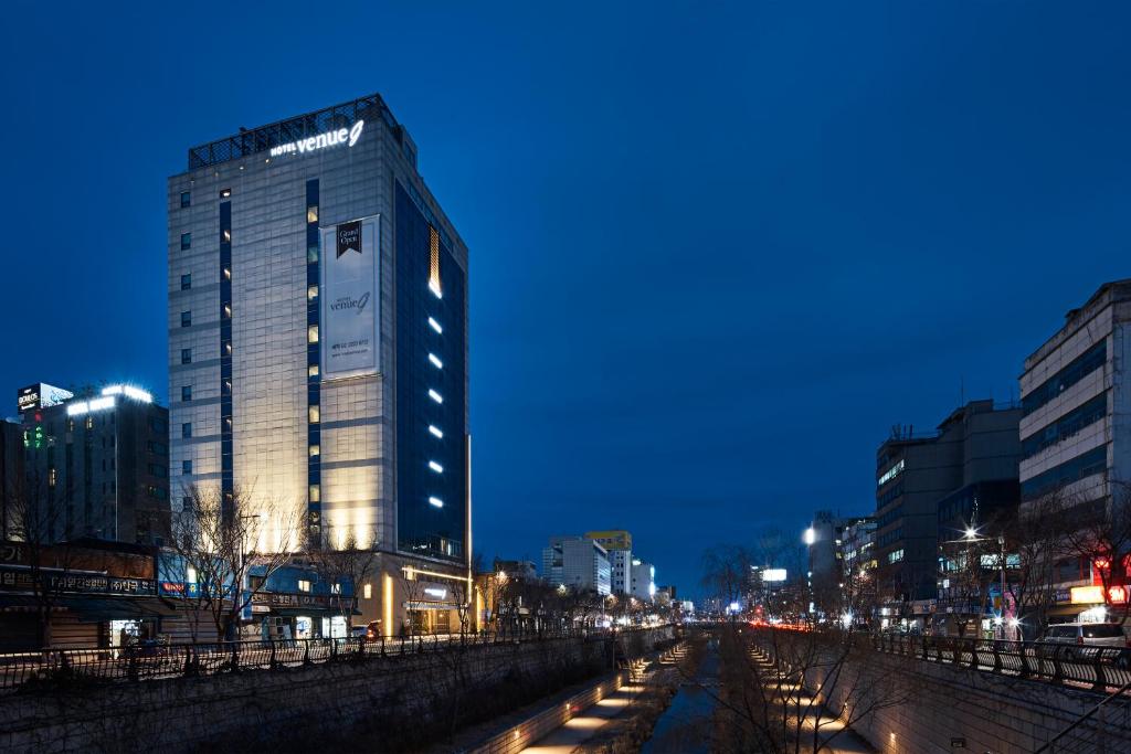 a tall building in a city at night at Hotel Venue-G Seoul in Seoul