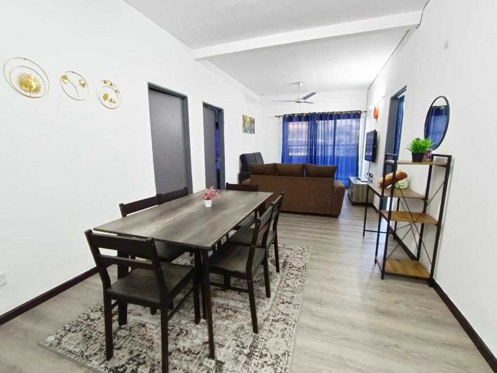 a dining room and living room with a table and chairs at IRDINA HomestayMuslim's 2 at Emerald Avenue Brinchang Centrum in Brinchang