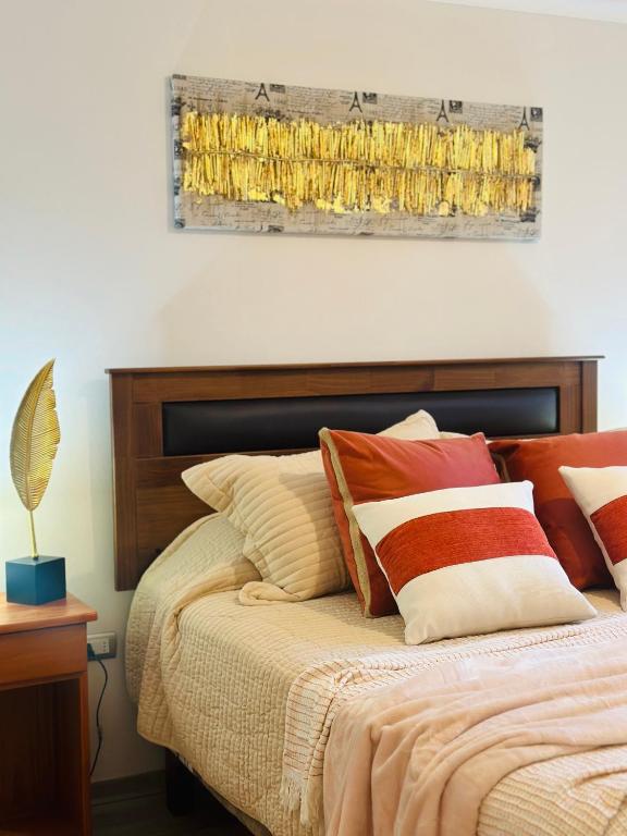 a bedroom with a bed with pillows on it at Desconexión y Paz in Pucón