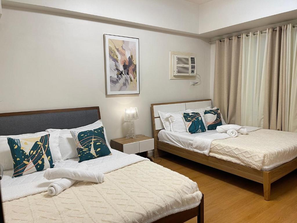Ένα ή περισσότερα κρεβάτια σε δωμάτιο στο 1 Bedroom Homestay in 8 Adriatico Manila