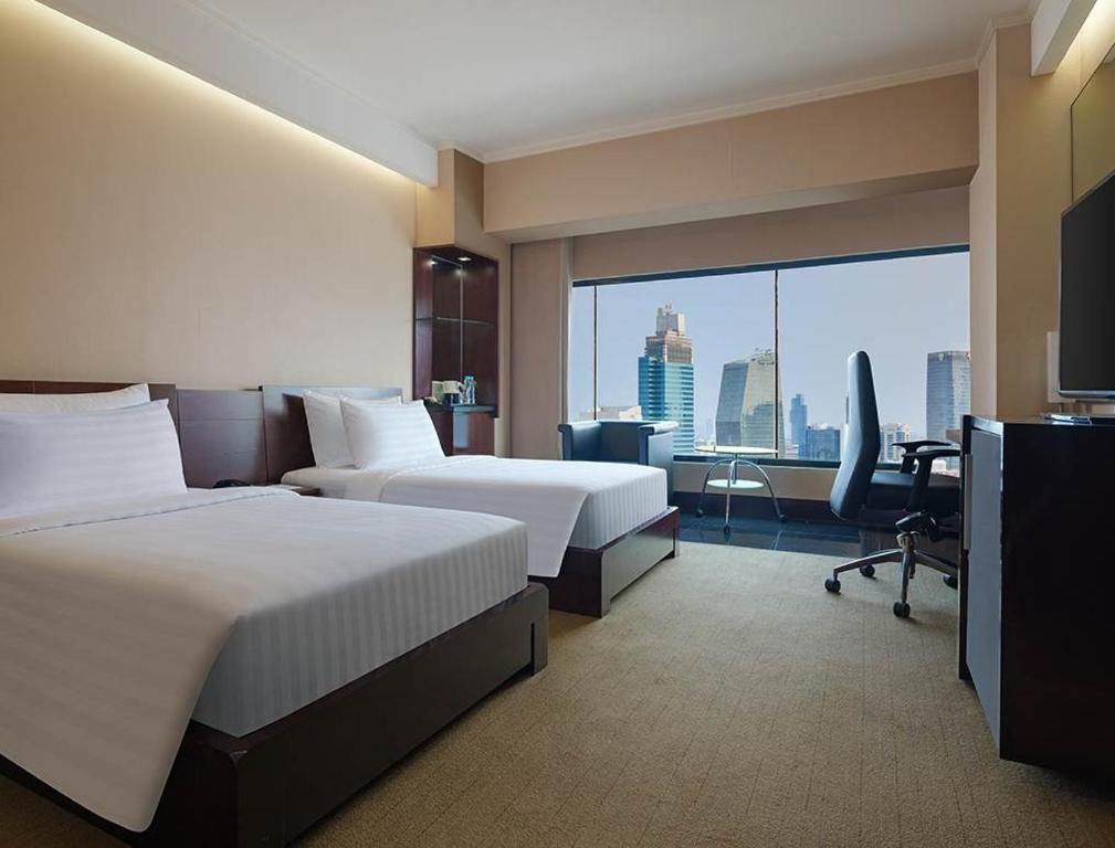 Ένα ή περισσότερα κρεβάτια σε δωμάτιο στο Manhattan Hotel Jakarta