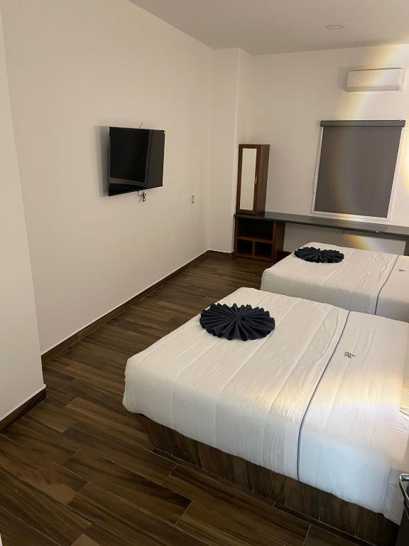 Postel nebo postele na pokoji v ubytování Hotel ANB Aeropuerto Guadalajara