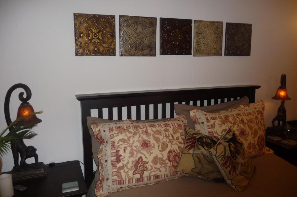 a bedroom with a bed with pillows on it at Magnolia Petal in Ganges