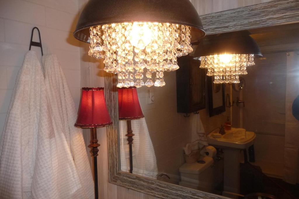 a bathroom with two chandeliers and a mirror at Magnolia Petal in Ganges