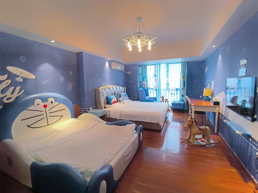 a childrens bedroom with two beds and a blue wall at FRAGRANCE House Hanxi Changlong Panyu Wanda Plaza Store in Guangzhou