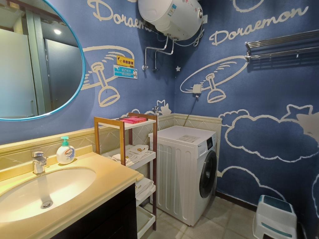 a bathroom with a sink and a washing machine at FRAGRANCE House Hanxi Changlong Panyu Wanda Plaza Store in Guangzhou