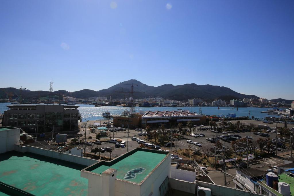 a large body of water with buildings at Dorcas Tourist Hostel in Tongyeong