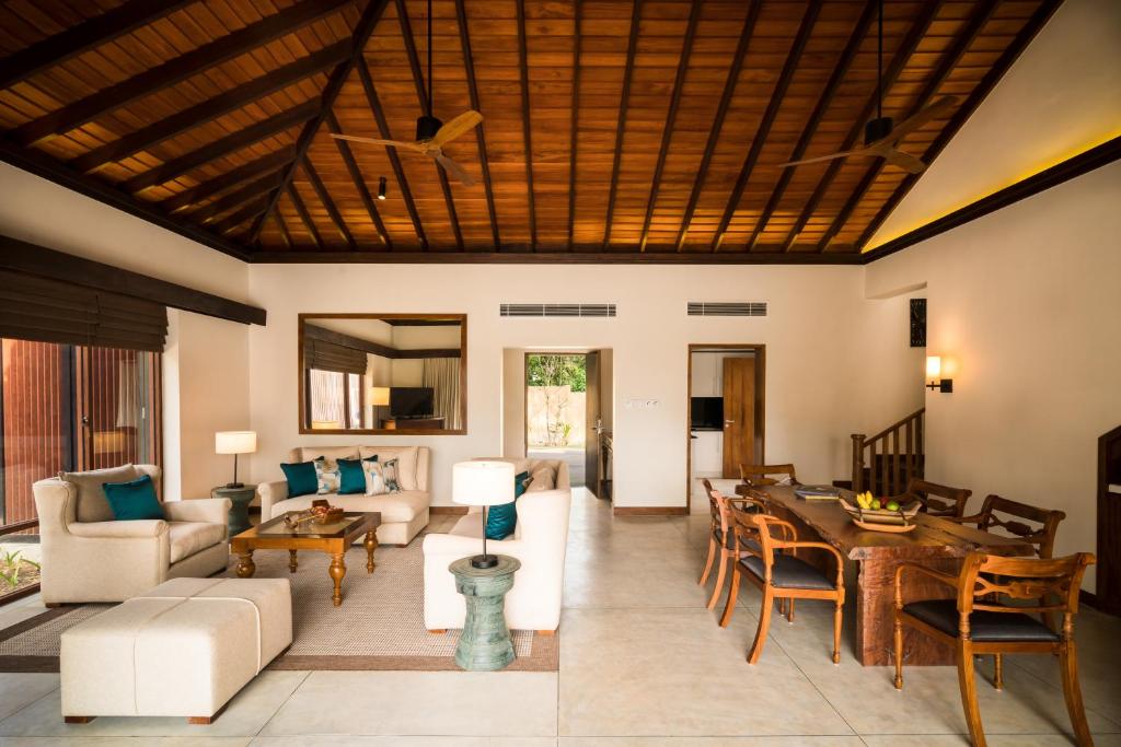 an open living room with a wooden ceiling at Anantara Peace Haven Tangalle Resort in Tangalle