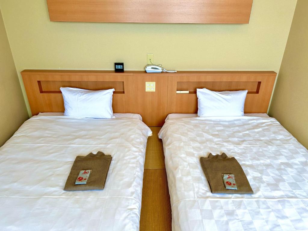 Postel nebo postele na pokoji v ubytování Concept Hotel Wakyu