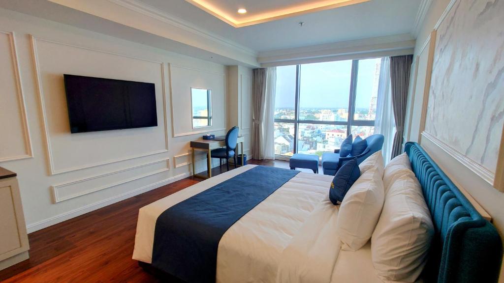 Postel nebo postele na pokoji v ubytování Cosmo Stars Hotel Bạc Liêu