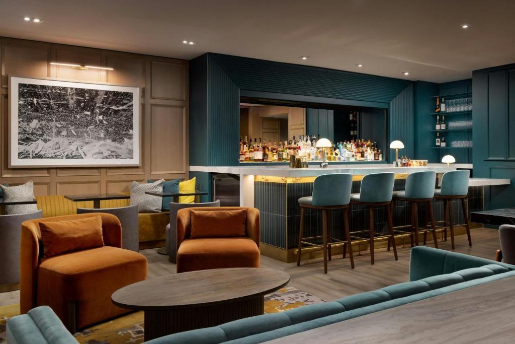 a bar in a restaurant with chairs and tables at Residence Inn by Marriott New York Downtown Manhattan/World Trade Center Area in New York