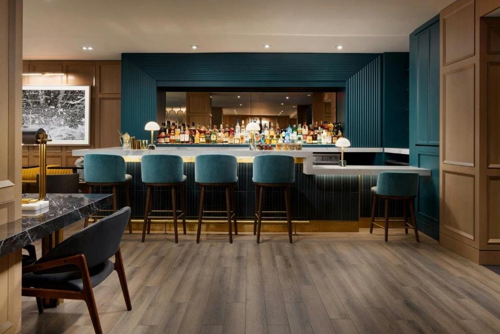 a bar with blue bar stools in a restaurant at Residence Inn by Marriott New York Downtown Manhattan/World Trade Center Area in New York