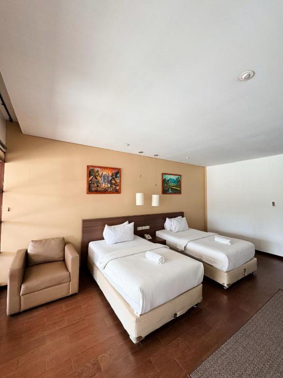 Postel nebo postele na pokoji v ubytování Hotel Ompu Herti