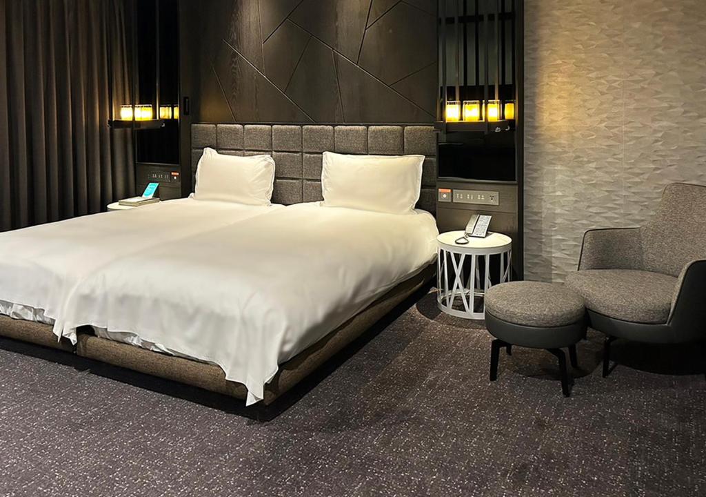 Postel nebo postele na pokoji v ubytování Hotel Château Anping