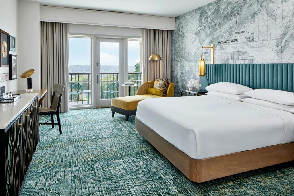 a hotel room with a large bed and a desk at Renaissance Shoals Resort & Spa in Florence