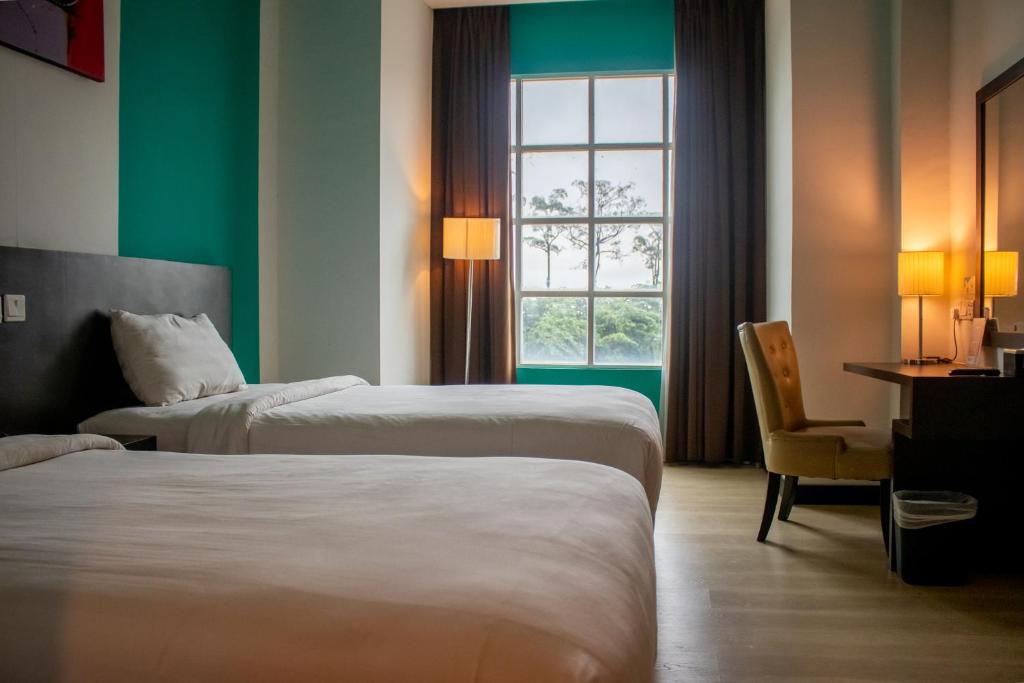 Кровать или кровати в номере King's Hotel Nagoya Batam