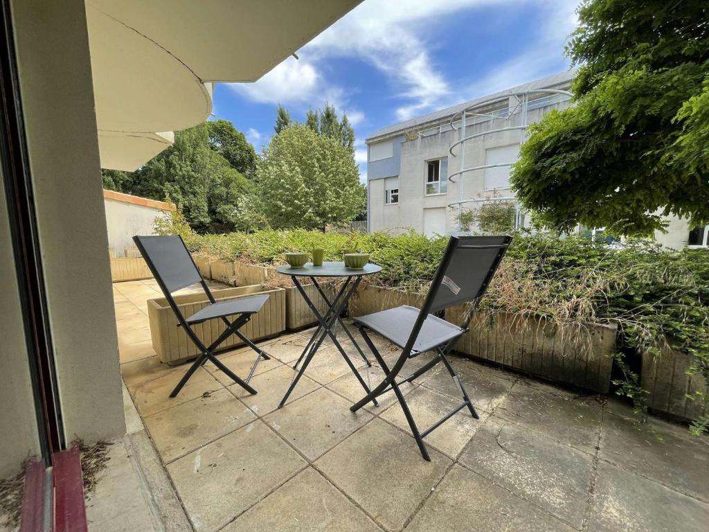 two chairs and a table on a patio at Appt Studio LA ROCHELLE - LR010-031 in La Rochelle