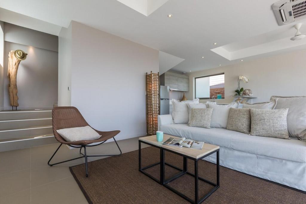 a living room with a white couch and a table at 2br boutique style villa Lipe in Bang Rak Beach