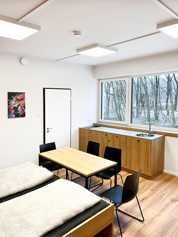 a room with a table and chairs and a sink at Erlebniswelt Resort Apartment 4 in Reken