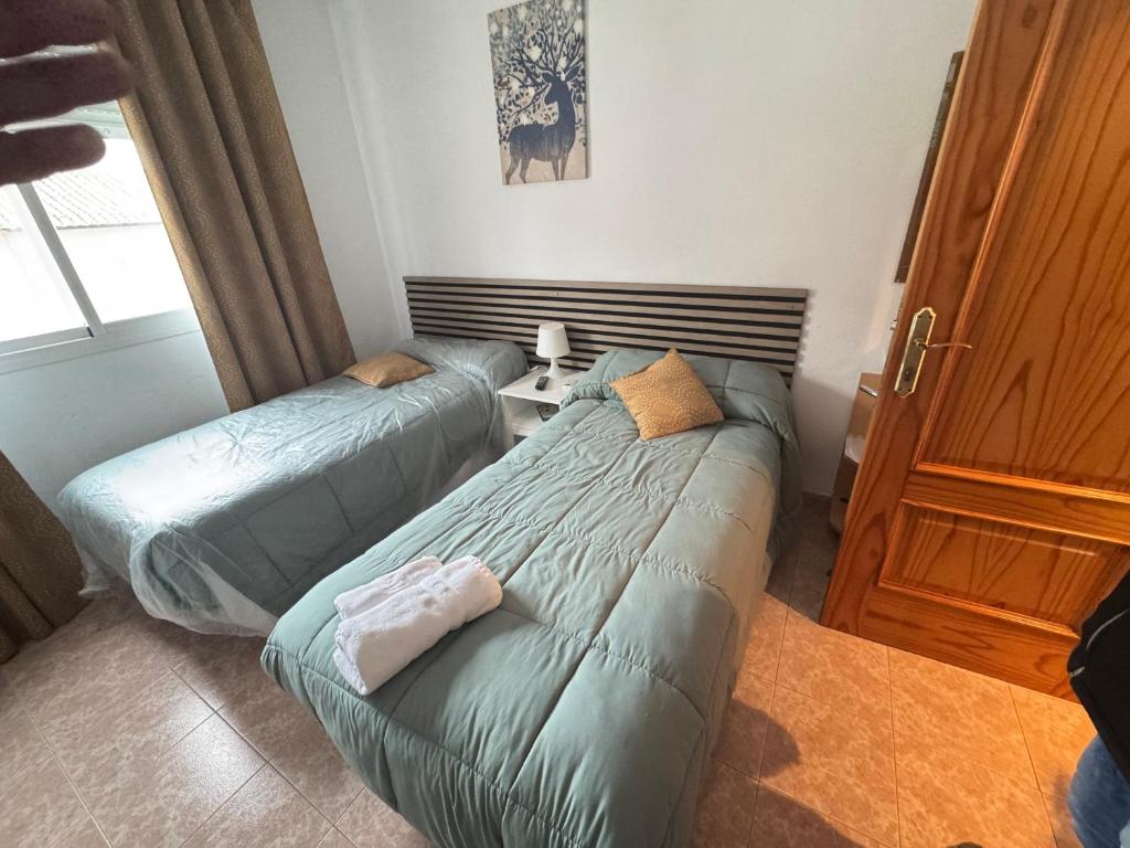 a bedroom with two beds at Hostal Vaticano in Alfajarín