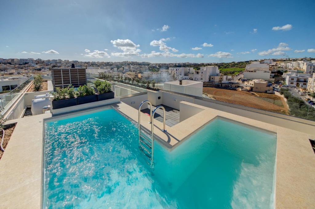 a swimming pool on the roof of a house at Kuya -Private 2BR Penthouse with Pool & Sunbeds By JL in Is-Swieqi
