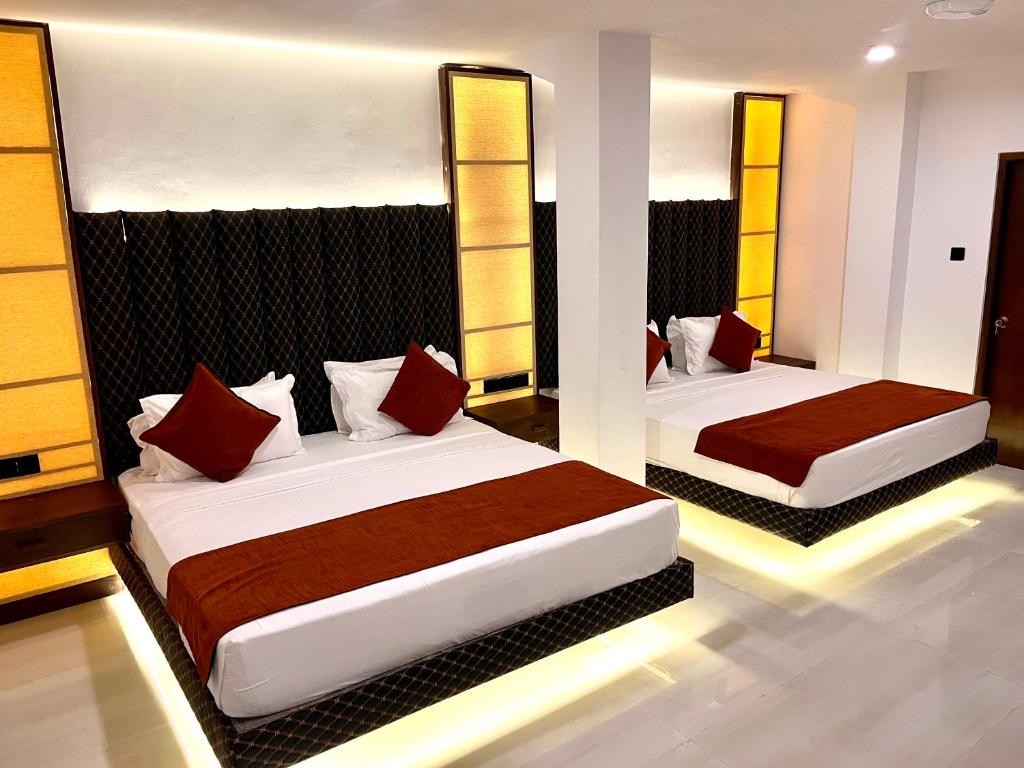 Postel nebo postele na pokoji v ubytování Sundaras Family Suites