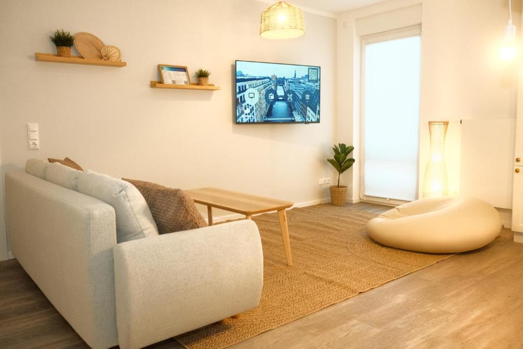TV a/nebo společenská místnost v ubytování Seepferdchen Strandträume - 5 min zu Fuß zum Strand